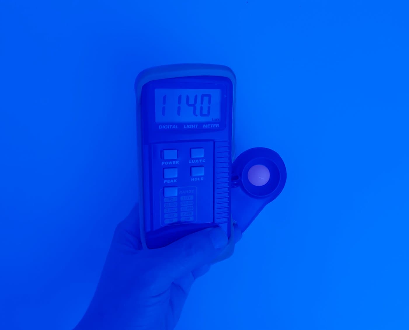 Luxmeter reading 114 lux from blue LED strip in mining tunnel