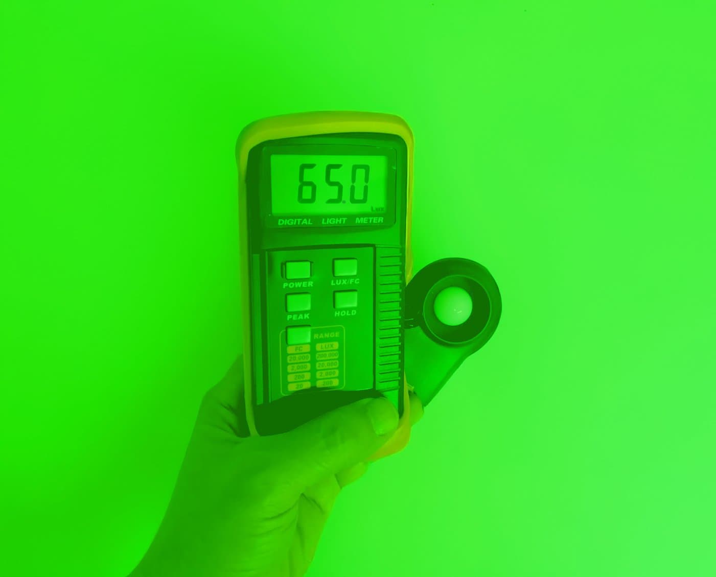 Luxmeter reading 65 lux from green LED strip in mining tunnel